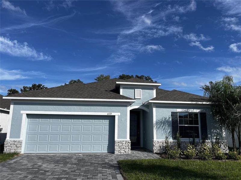 Front exterior of a new home in Villa Pass, Mascotte, FL, highlighting curb appeal (Image 1).