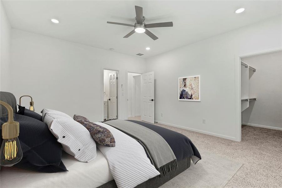 Carpeted bedroom featuring recessed lighting, a walk in closet, and ceiling fan