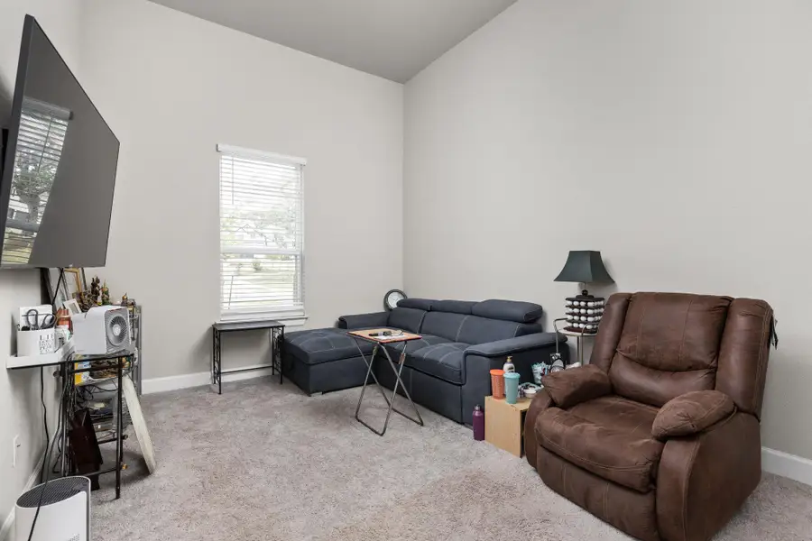 Living room featuring light colored carpet and baseboards