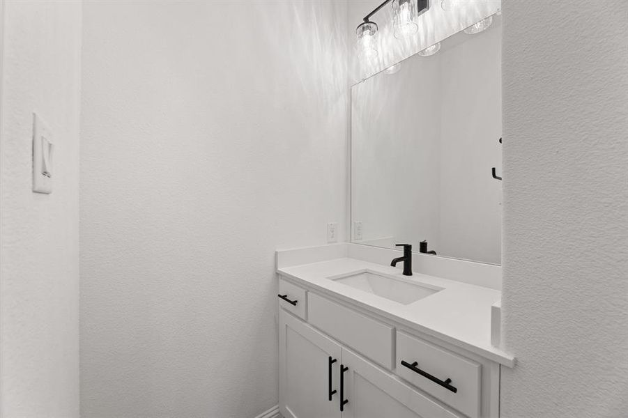 Bathroom with a textured wall and vanity Bathroom with a textured wall and vanity