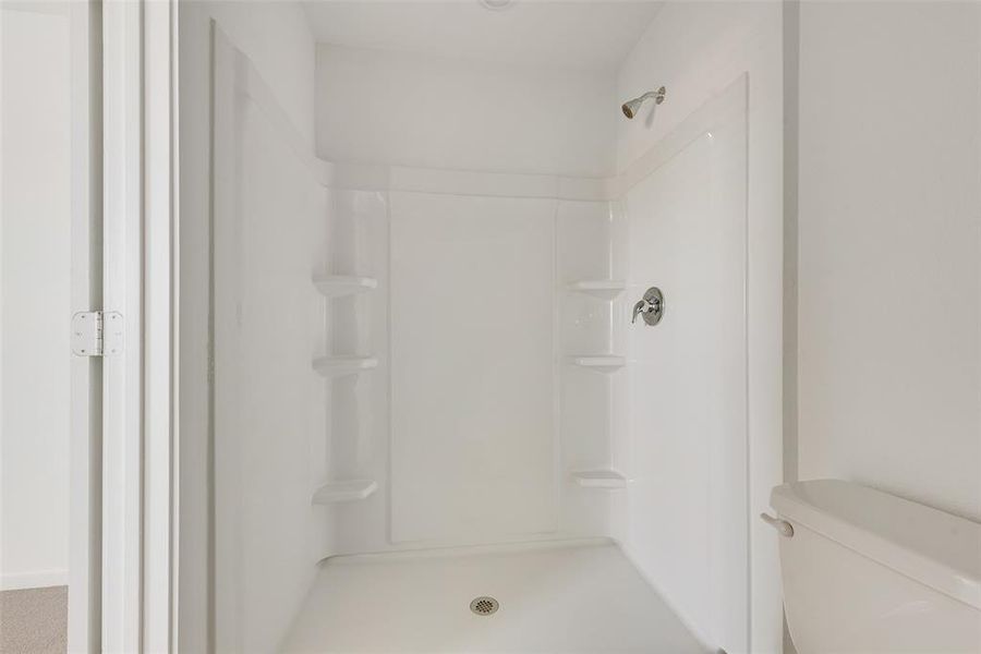 Bathroom with toilet and walk in shower