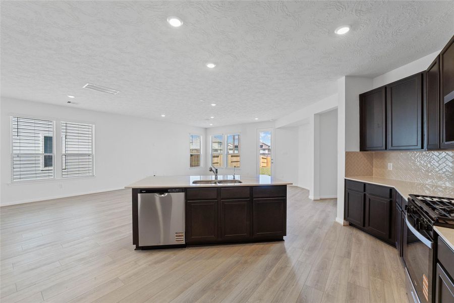 A true chef’s dream, the kitchen island adds additional cabinet and countertop space—with views of the backyard. A true chef’s dream, the kitchen island adds additional cabinet and countertop space—with views of the backyard.