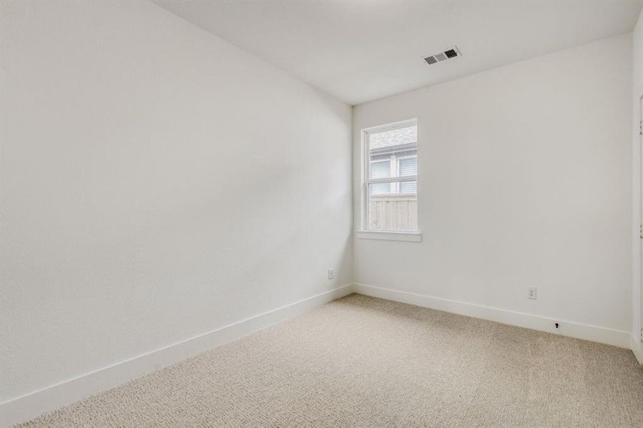 Carpeted spare room featuring baseboards Carpeted spare room featuring baseboards