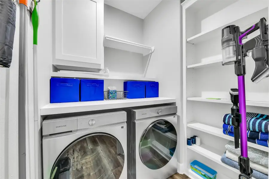 In house laundry room with additional storage space
