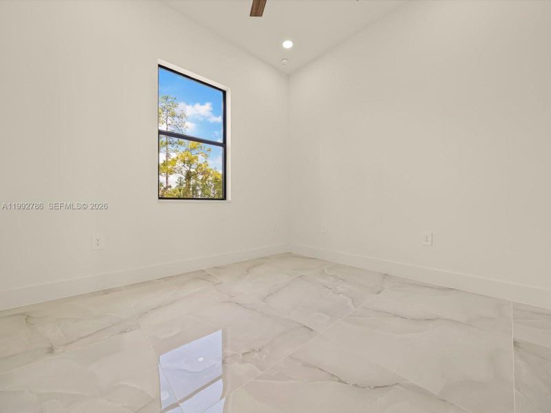 Den with en-suite half-bathroom and outdoor access