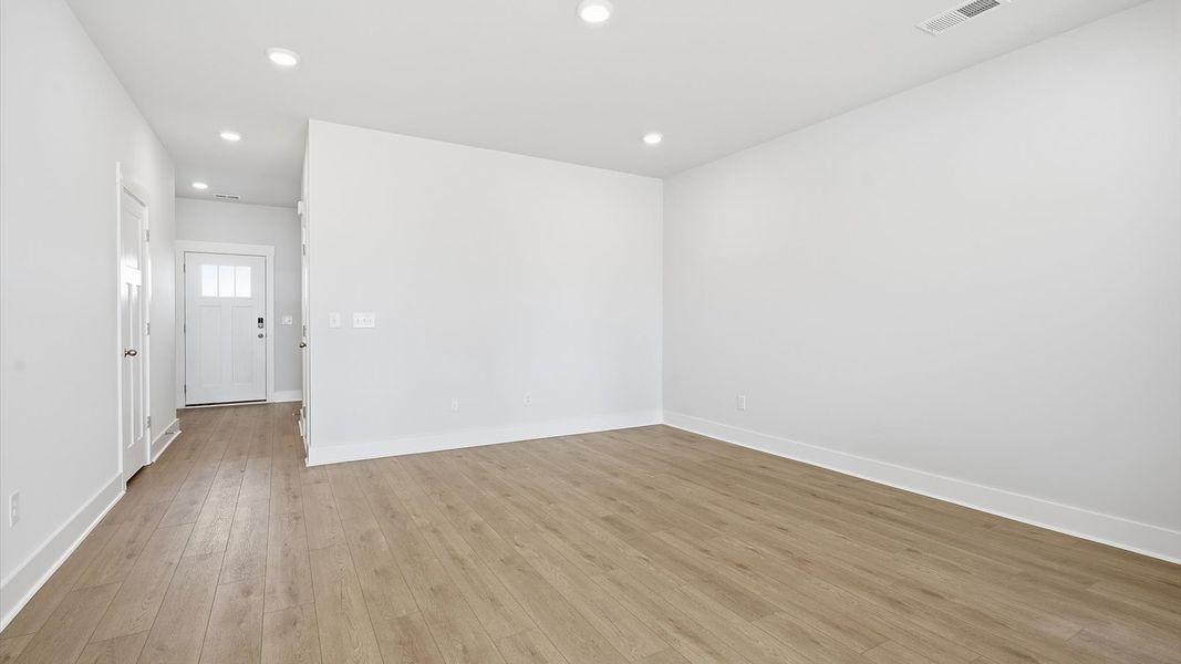First-rate living space with tasteful hardwood floors and a functional open-concept design by DRB Homes