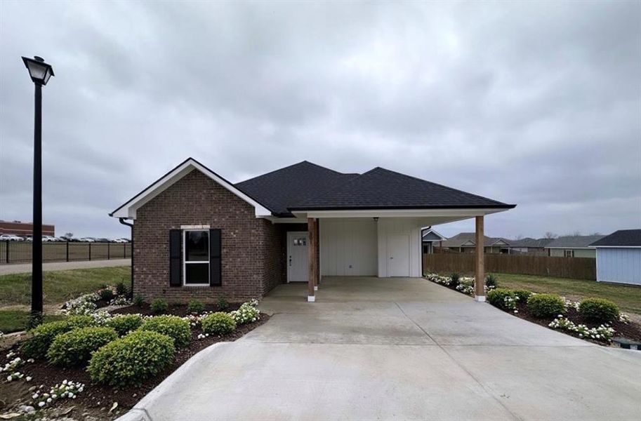 View of front of property featuring a carport