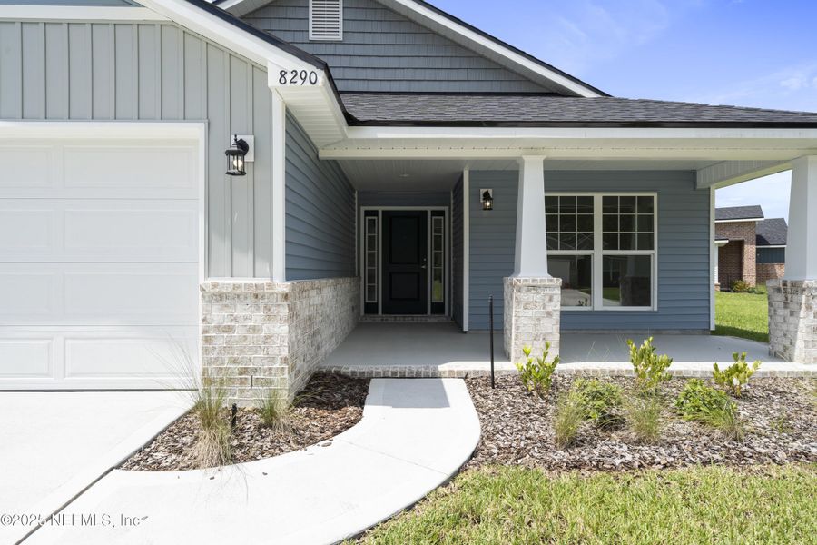 Front exterior of a new home in Summerglen, Jacksonville, FL, highlighting curb appeal (Image 1).
