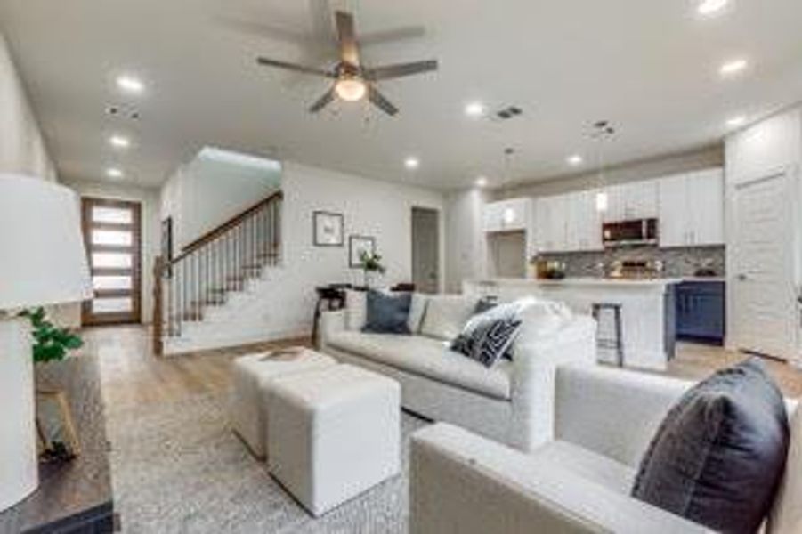 Living room featuring light hardwood / wood-style floors and ceiling fan