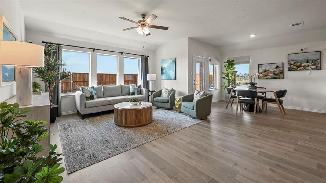 Living room featuring light wood finished floors, ceiling fan, and recessed lighting