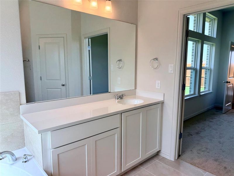 Vanity featuring a single-basin sink, chrome faucet, and white countertop