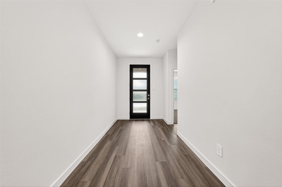Front Entry: Inside, luxury vinyl plank flooring flows throughout the main living areas, creating a modern and upscale feel.
