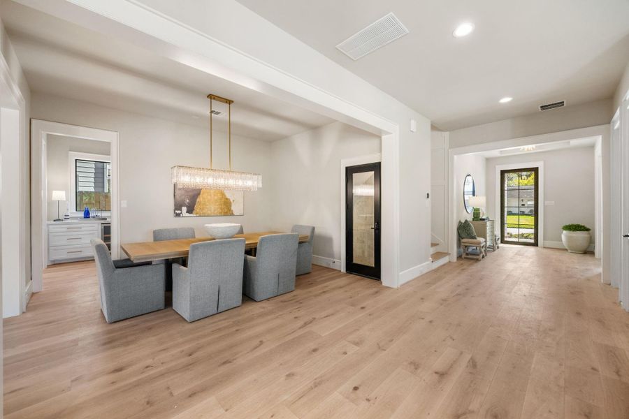 Formal Dining Room offers a designer selected chandelier & temp controlled wine room adorned w/ tumbled travertine. Butler's Pantry sits behind the Dining Room w/ an entrance to the Kitchen, Mudroom & walk-in Pantry.