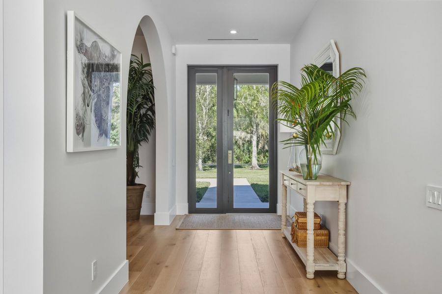 Foyer entrance with massive doors and covered entry with pendant