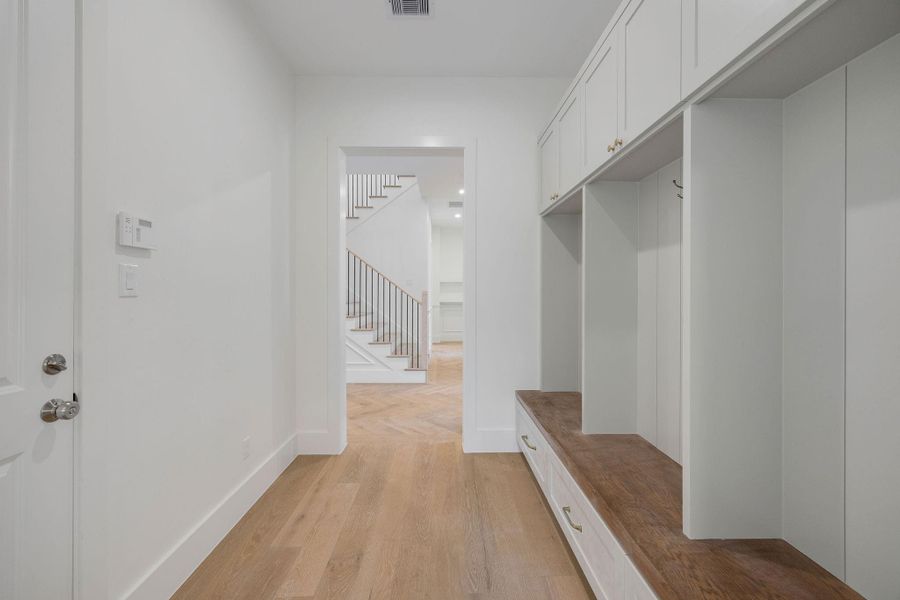 The mud room provides a dedicated place for belongings. It connects to the scullery and entryway, creating a flowing layout throughout the home. The mud room provides a dedicated place for belongings. It connects to the scullery and entryway, creating a flowing layout throughout the home.