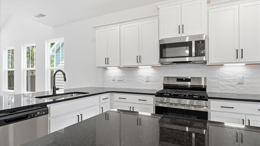 Highly functional kitchen offering a refined look and practical island at the center Highly functional kitchen offering a refined look and practical island at the center