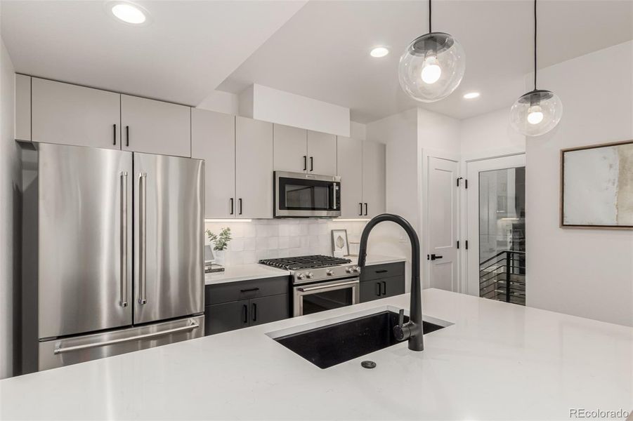 Counter space, storage, large pantry. Back door out to garage.