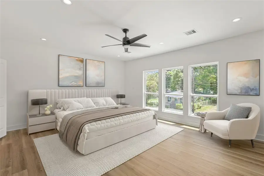 Retreat to this spacious primary bedroom, where large windows flood the room with natural light and a ceiling fan adds year-round comfort. The peaceful ambiance and generous layout make it the perfect place to unwind, come see it in person and imagine yourself at home. Photo is virtually staged.