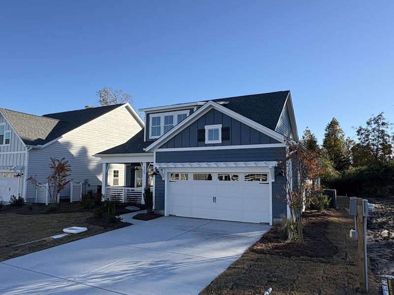 Front exterior of a new home in Riverside Cove, Wilmington, NC, highlighting curb appeal (Image 2).