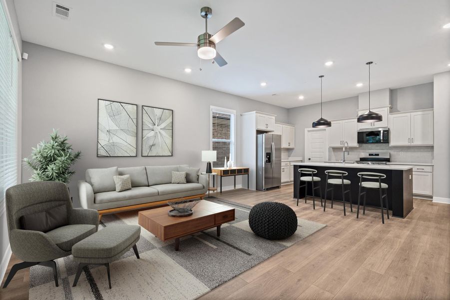 Open-concept living space featuring wood-finish flooring throughout Open-concept living space featuring wood-finish flooring throughout