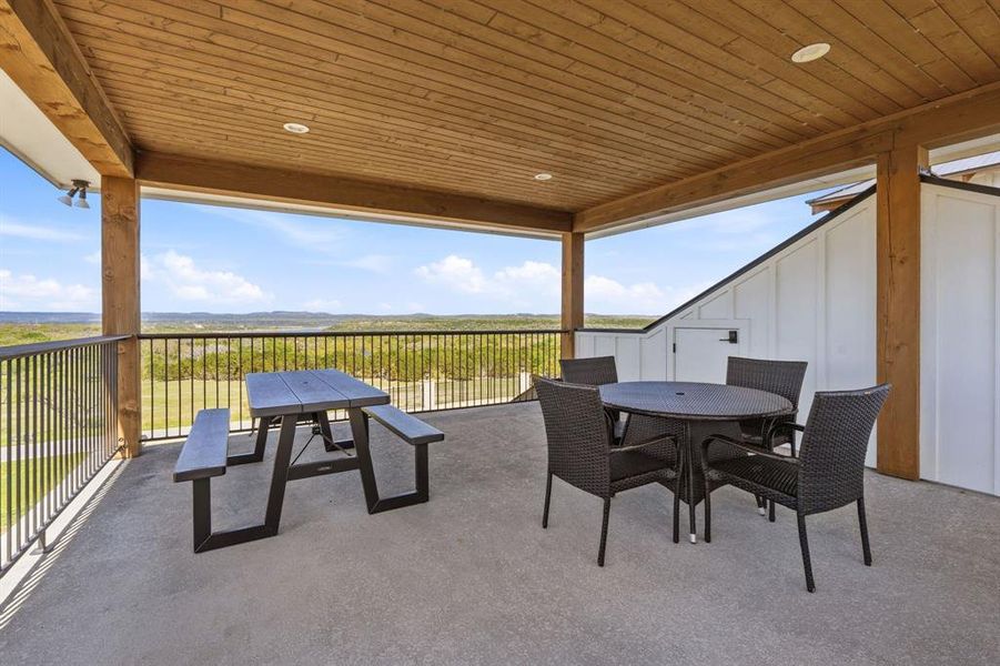 An inviting covered deck offers sweeping panoramic views of the surrounding natural landscape, ideal for outdoor gatherings.