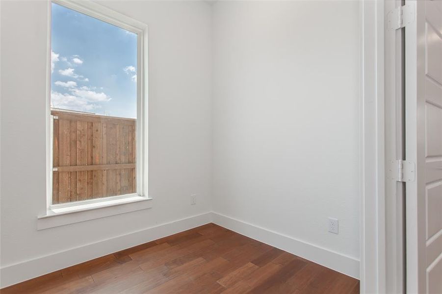 Empty room featuring hardwood / wood-style floors