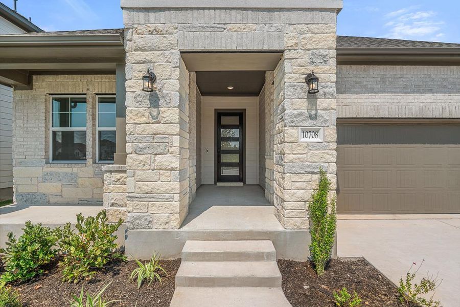Front exterior of a new home in Lagos Reserve, Manor, TX, highlighting curb appeal (Image 19). Front exterior of a new home in Lagos Reserve, Manor, TX, highlighting curb appeal (Image 19).