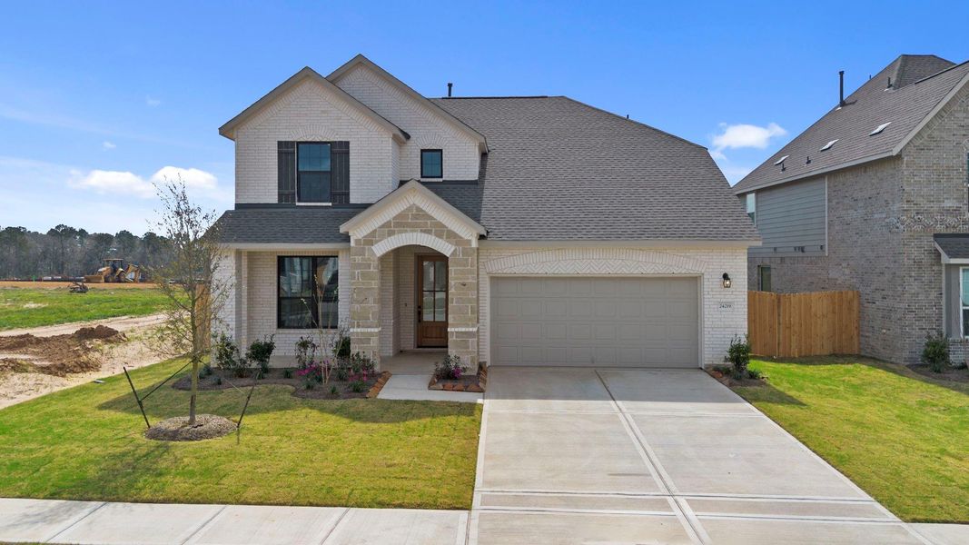 Front exterior of a new home in Spring Creek Trails, Magnolia, TX, highlighting curb appeal (Image 21).