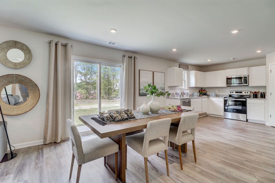 A kitchen with a dining table.