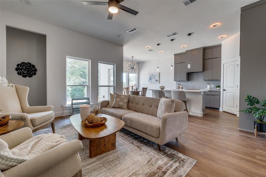 Living room featuring light hardwood / wood-style floors and ceiling fan