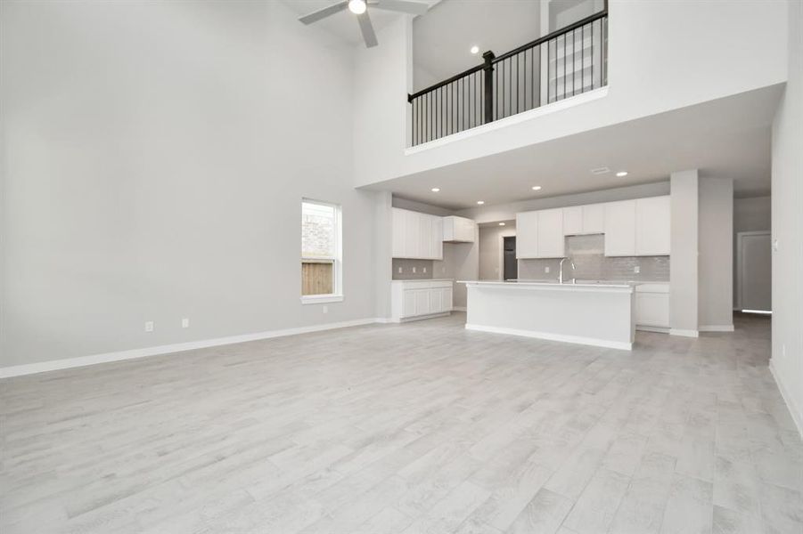 Another view of the living room area, heart of the home. Sample photo of completed home with similar floor plan. As-built interior colors and selections may vary.