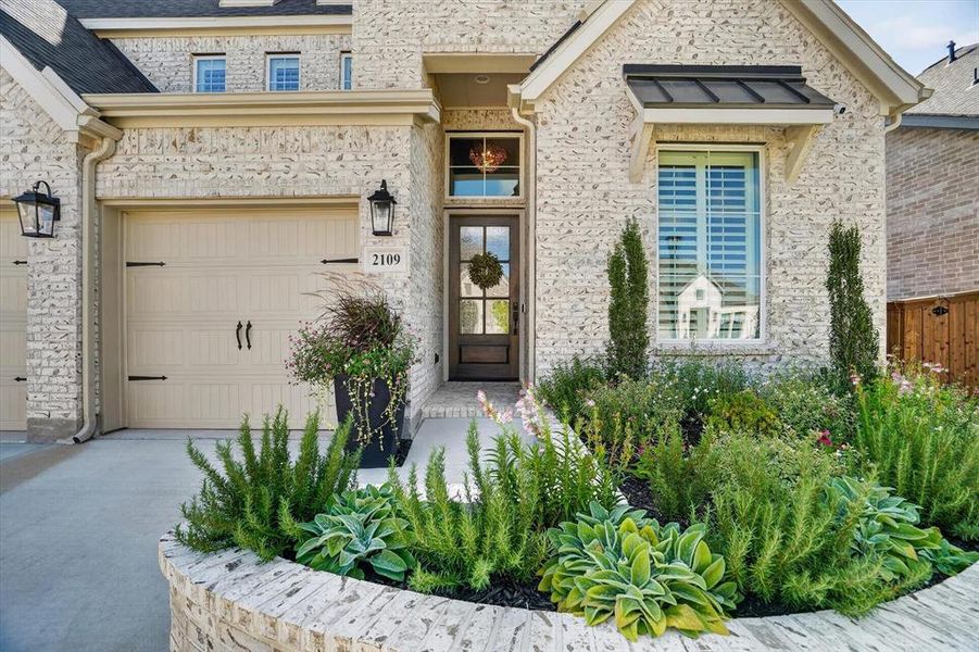 Stone brick facade featuring a dark wood entry door with glass panels Stone brick facade featuring a dark wood entry door with glass panels