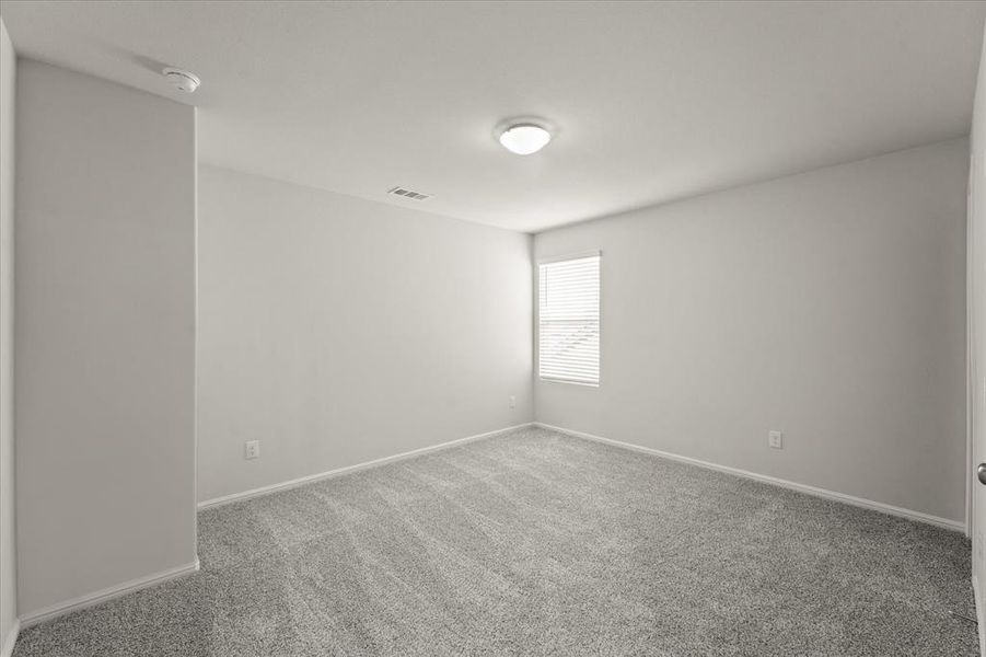 Spare room featuring carpet flooring