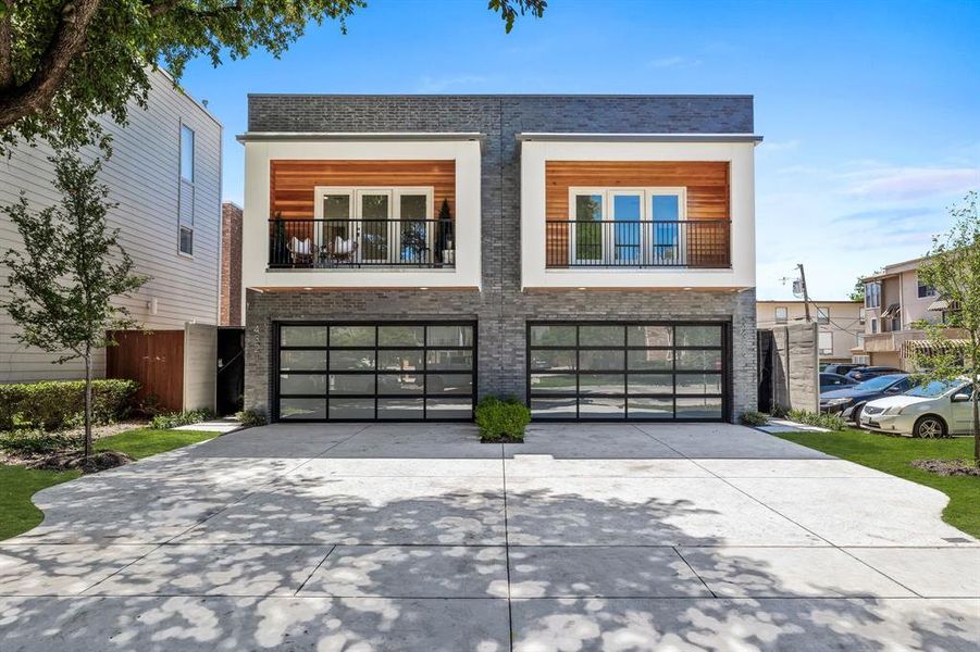 View of front facade with a garage and a balcony