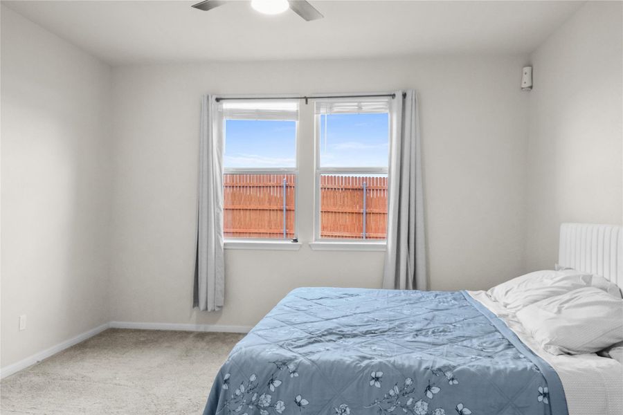 Bedroom with carpet flooring and a ceiling fan