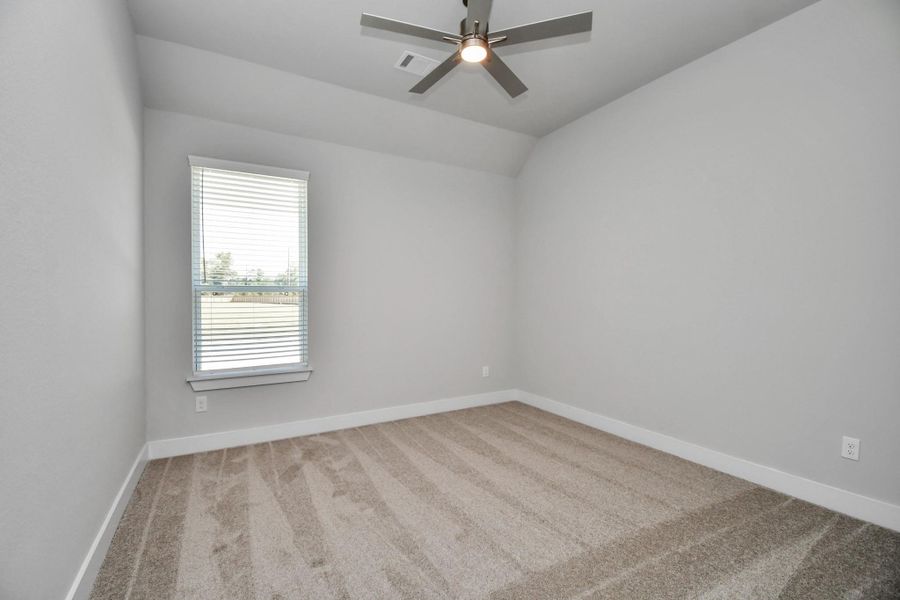 Secondary bedroom features plush carpeting, large windows that let in plenty of natural light, bright paint, and spacious closets. Sample photo of completed home with similar floor plan. Actual colors and selections may vary. Secondary bedroom features plush carpeting, large windows that let in plenty of natural light, bright paint, and spacious closets. Sample photo of completed home with similar floor plan. Actual colors and selections may vary.