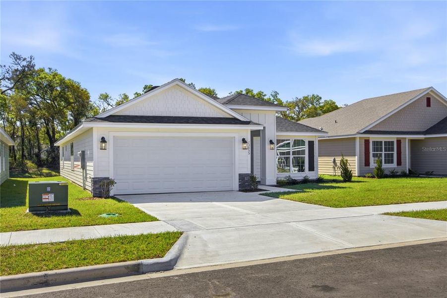 Front exterior of a new home in Briarwood, Alachua, FL, highlighting curb appeal (Image 17).