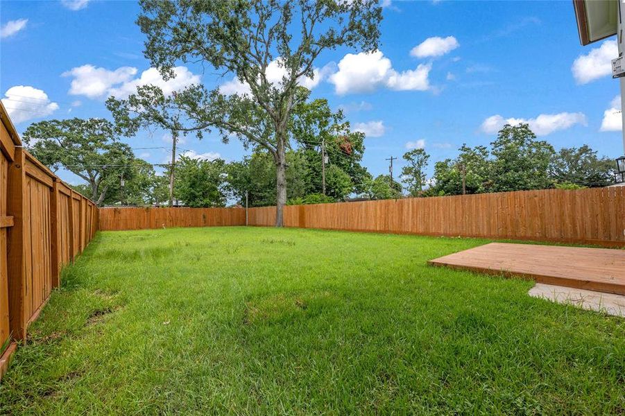Fully fenced yard with front & back sprinkler system & mature trees around Fully fenced yard with front & back sprinkler system & mature trees around