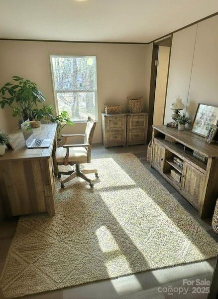 Bedroom off living room virtually staged as office