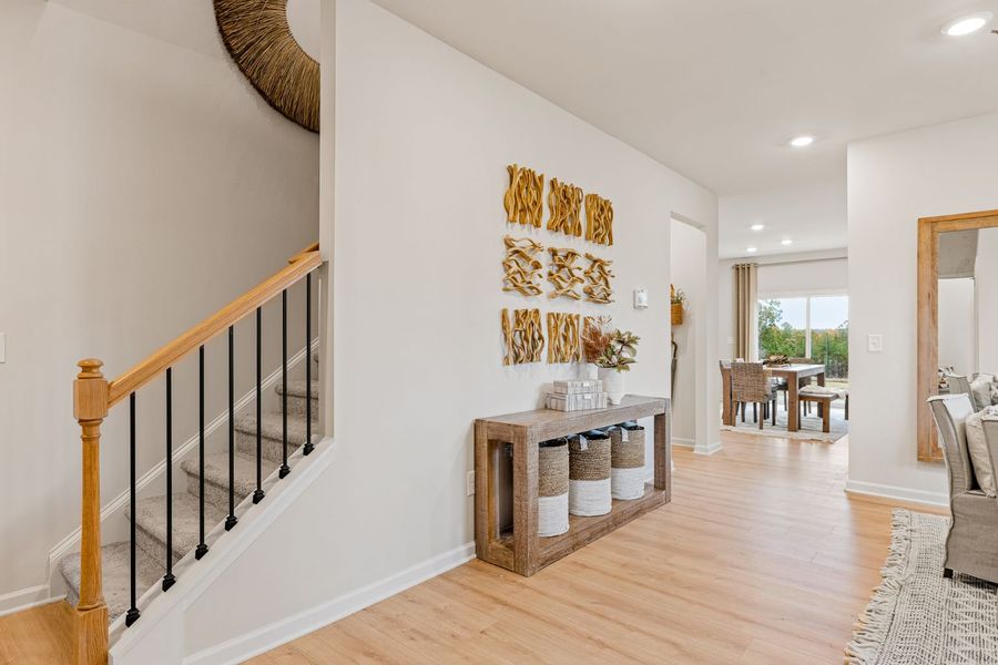 A room with a wood floor and a wood staircase. A room with a wood floor and a wood staircase.