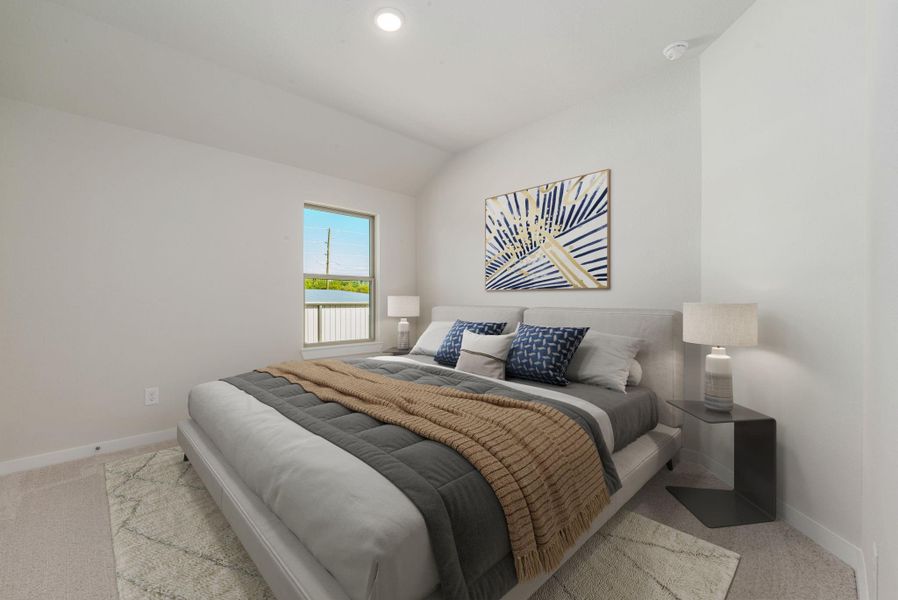 This inviting secondary bedroom features soft tones, elevated ceilings, and a large window that fills the space with natural light. Ideal for guests or family, it offers both comfort and versatility.