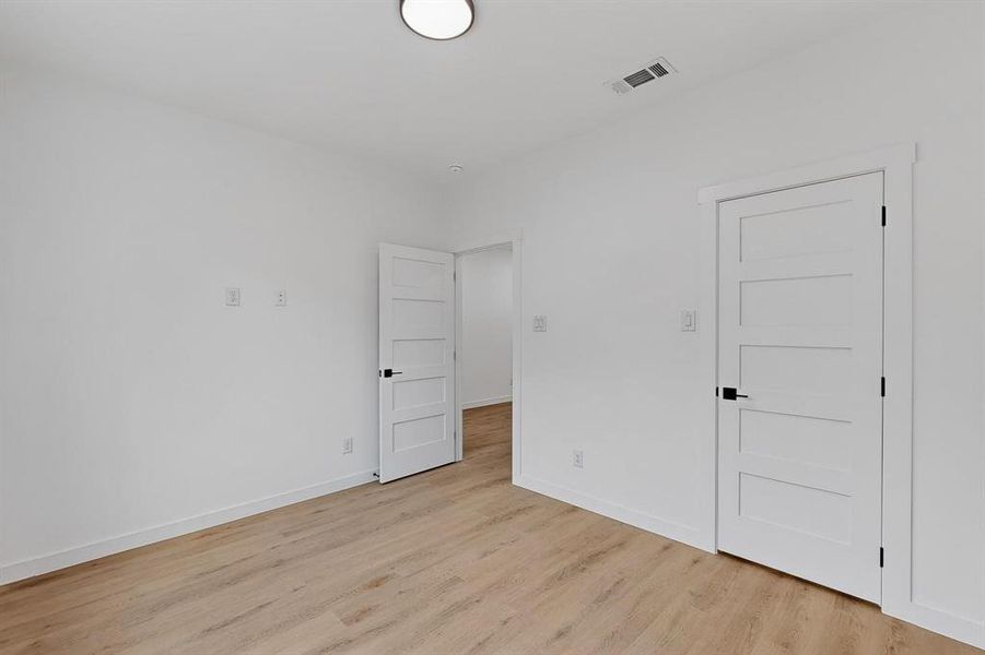 Empty room featuring light wood-style flooring and baseboards Empty room featuring light wood-style flooring and baseboards