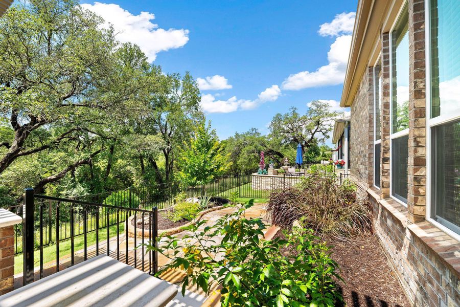 A tranquil outdoor living space with mature trees, vibrant greenery, and clear skies overhead. A tranquil outdoor living space with mature trees, vibrant greenery, and clear skies overhead.
