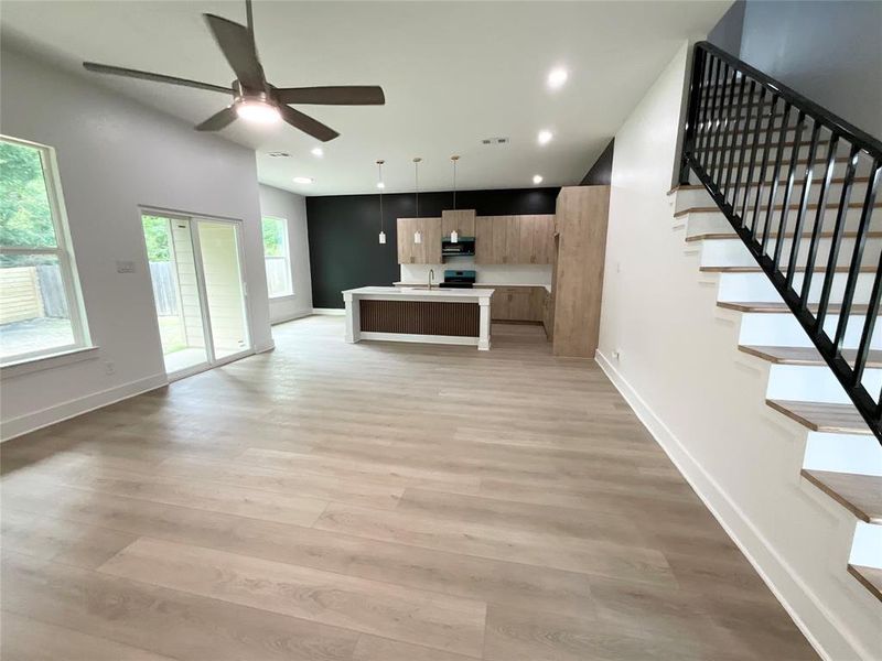 Spacious open-concept interior featuring light wood-finish flooring throughout Spacious open-concept interior featuring light wood-finish flooring throughout