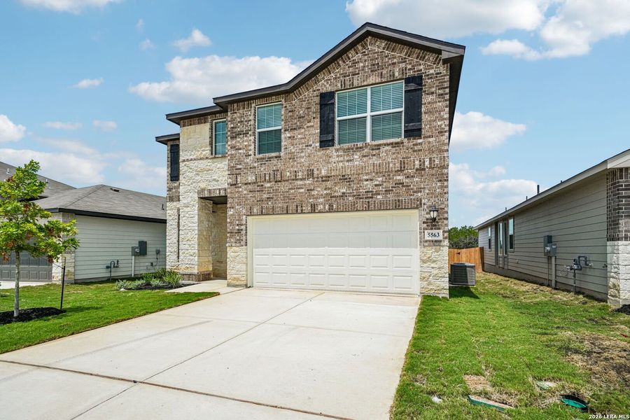 Front exterior of a new home in Thomas Pond, San Antonio, TX, highlighting curb appeal (Image 2). Front exterior of a new home in Thomas Pond, San Antonio, TX, highlighting curb appeal (Image 2).
