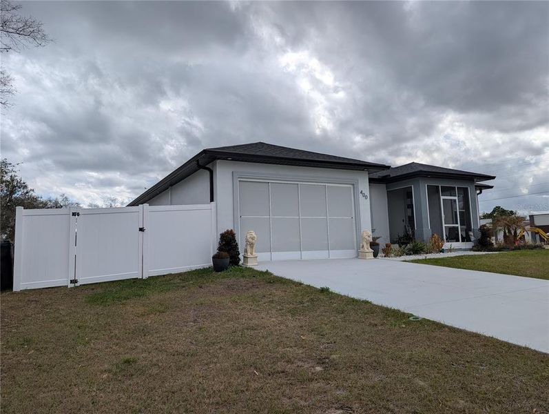 Front exterior of a new home in , Poinciana, FL, highlighting curb appeal (Image 20).
