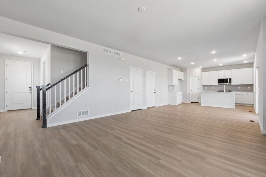 A large empty room with white doors. A large empty room with white doors.