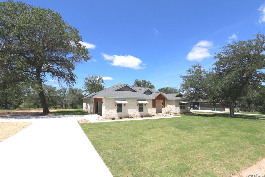 Front exterior of a new home in , La Vernia, TX, highlighting curb appeal (Image 2). Front exterior of a new home in , La Vernia, TX, highlighting curb appeal (Image 2).