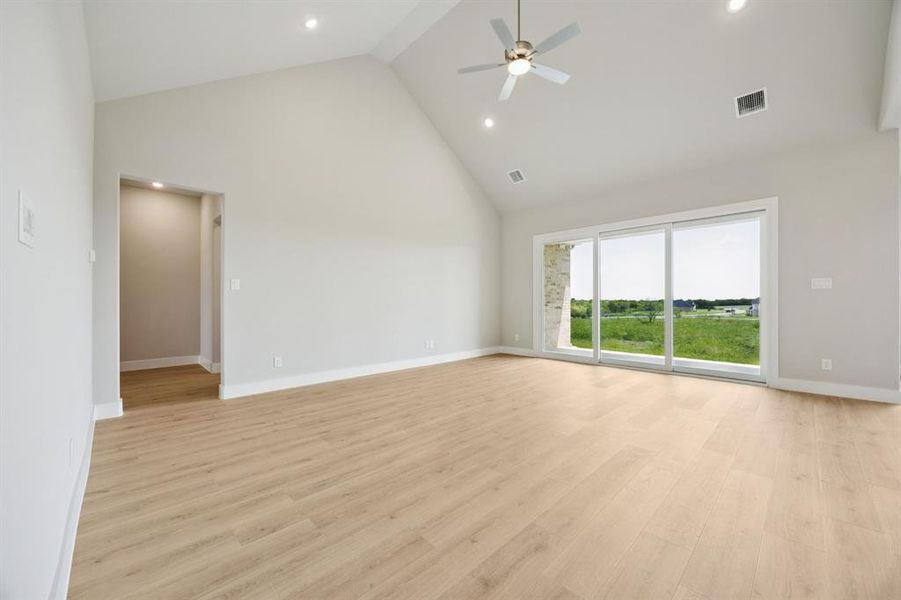 Unfurnished room with high vaulted ceiling, light wood-style floors, recessed lighting, and a ceiling fan