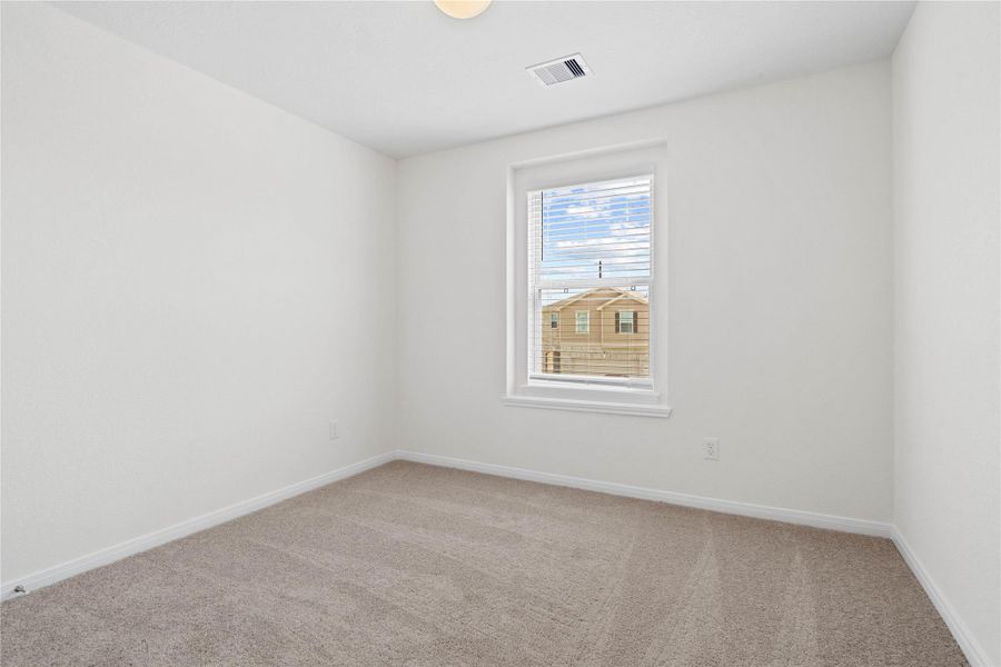 This secondary bedroom offers comfort and style with plush carpeting, neutral paint tones, globe lighting, a large window with blinds, and a generously sized closet. This secondary bedroom offers comfort and style with plush carpeting, neutral paint tones, globe lighting, a large window with blinds, and a generously sized closet.